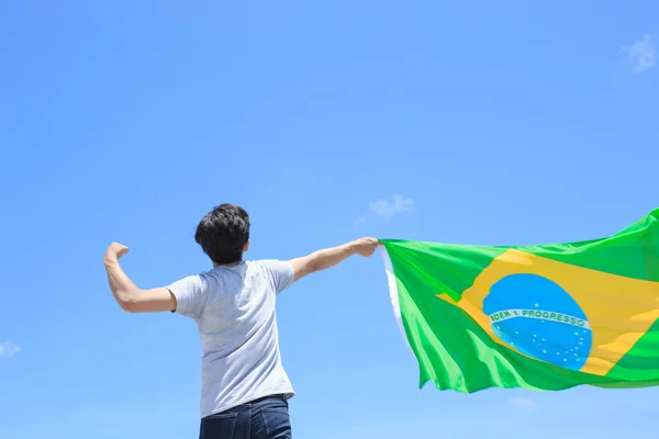 Ember gazdaság brazil zászlóval — Stock Fotó