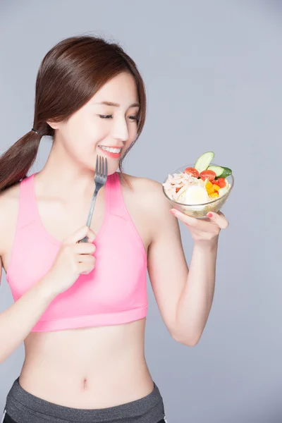 Mulher comendo salada e sorrindo — Fotografia de Stock