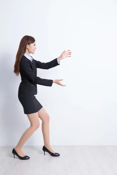 Business woman pushing something — Stock Photo, Image