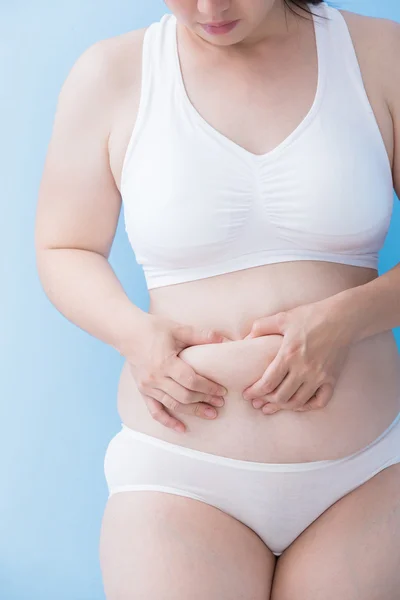 Woman evaluating fat under skin — Stock Photo, Image