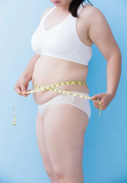 Woman measuring  waist with tape — Stock Photo, Image