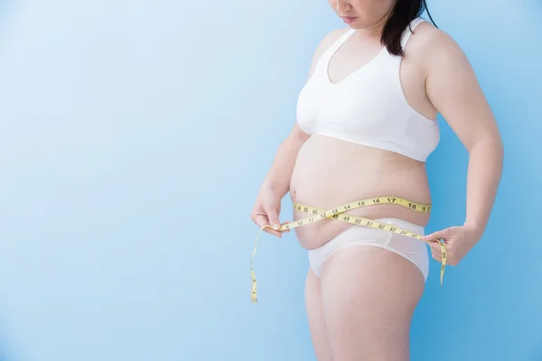 Woman measuring  waist with tape — Stock Photo, Image