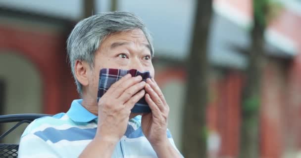 Starszy człowiek kichnąć na zewnątrz — Wideo stockowe