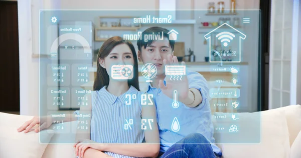 许多智能家居概念 亚洲夫妇按虚拟屏幕按钮打开空调 — 图库照片