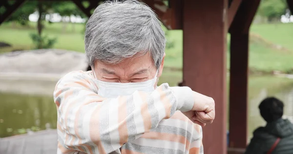 Asiatischer Älterer Mann Hustet Mit Chirurgischem Mundschutz Den Ellenbogen — Stockfoto