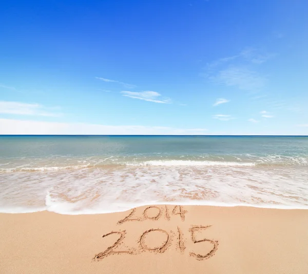 Inscription 2014 and 2015 on sand — Stock Photo, Image