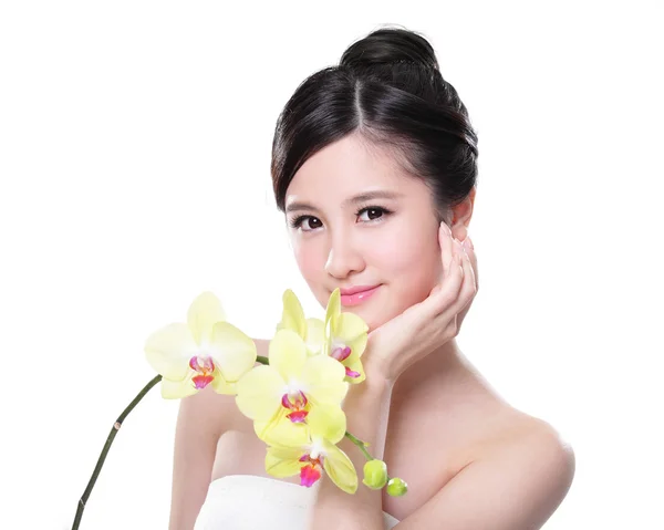 Beautiful woman with yellow orchids — Stock Photo, Image