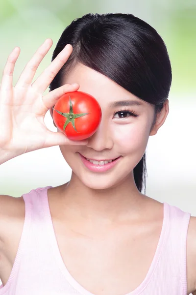 Girl showing tomato
