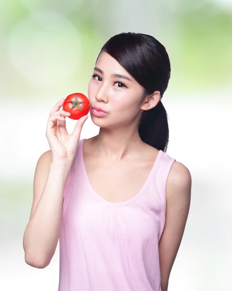 Girl showing tomato — Stock Photo, Image