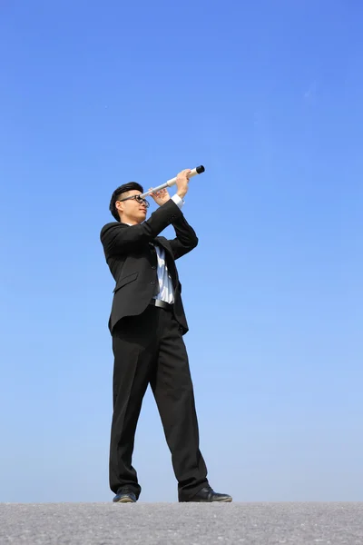 Businessman using telescope — Stock Photo, Image