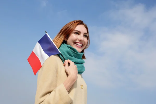 Kvinna anläggning fransk flagg — Stockfoto