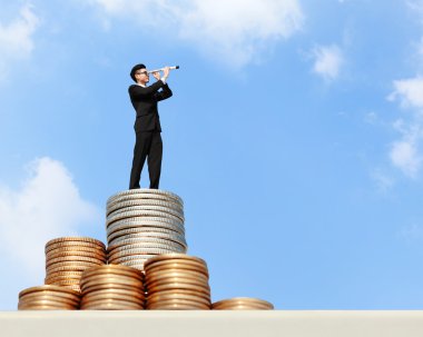 Business man standing on money clipart