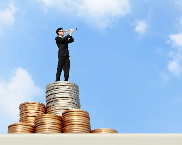 Business man standing on money — Stockfoto