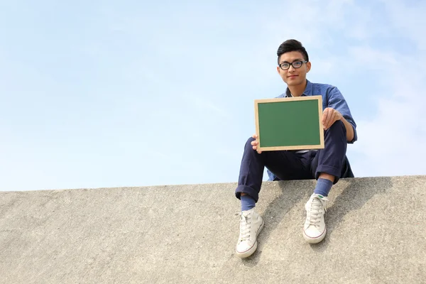 Happy man holding blackboard — Stock Photo, Image