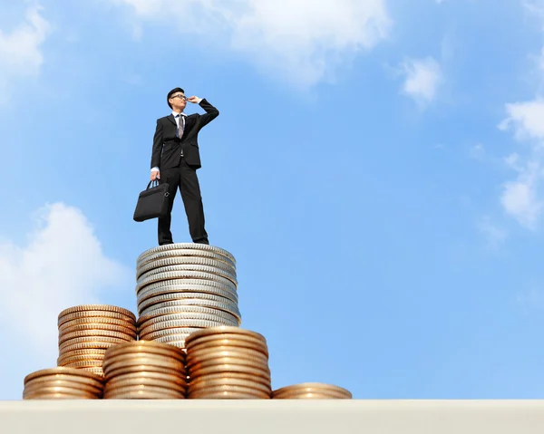 Business man stands on money — Stock Photo, Image