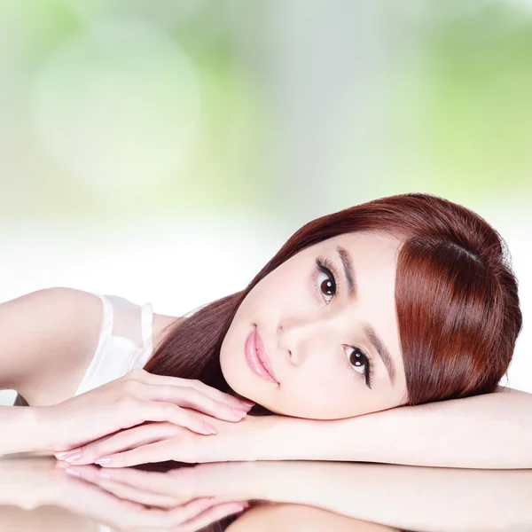 Woman lying down on mirror — Stock Photo, Image