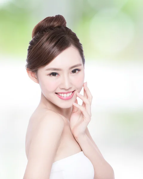 Woman smiling and touching skin — Stock Photo, Image