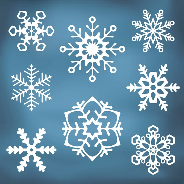 Ornate Snowflake silhouettes — Stock Vector