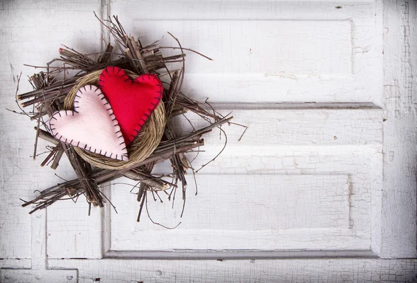 Two felt hearts in a nest — Stock Photo, Image