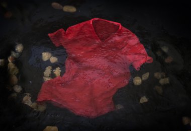 Red t-shirt floating  in water clipart