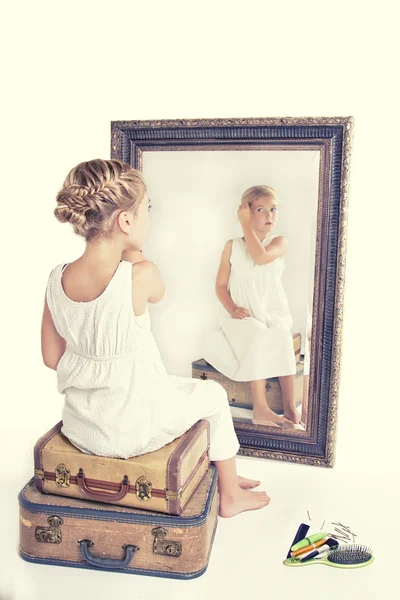 Dziecko, ustalenie jej włosy patrząc w lustro. — Zdjęcie stockowe