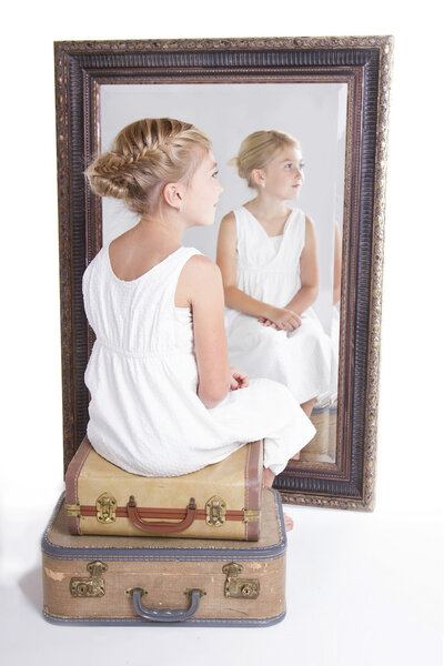 Child or young girl in front of a mirror