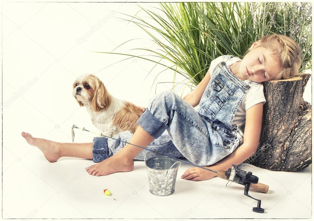 Child or young girl with her dog taking a nap or sleeping while 