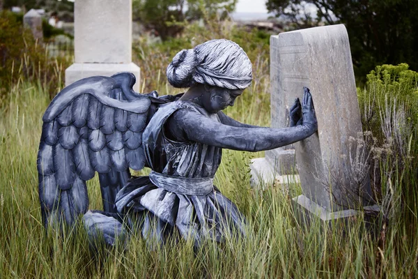 Girl wearing an angel costume in an old grave yard — Stock Photo, Image