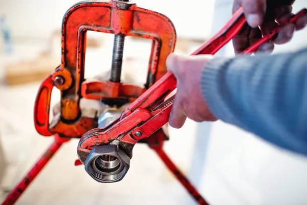 Plumber working with wrench and tools — Stock Photo, Image