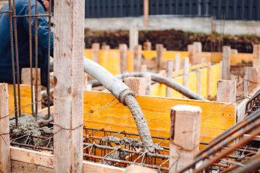 Endüstriyel inşaatta zeminin metal çubuklarının güçlendirilmesi üzerine beton döküm yakın çekim otur