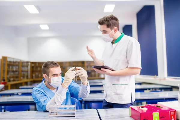Pharmacy students learning with tablet and practice in laboratory — Stock Photo, Image