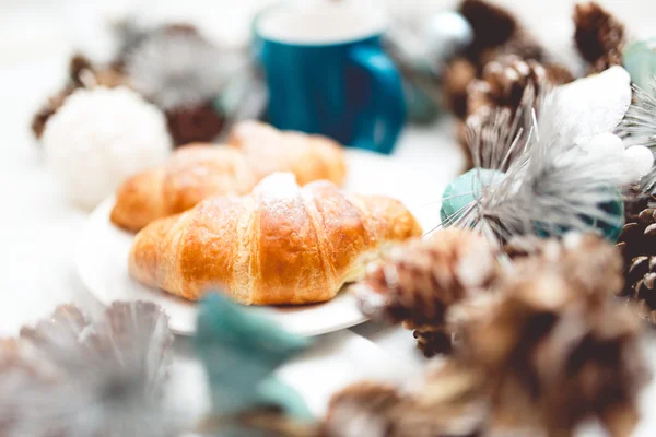 Closeup of fresh baked croissants served with milk on a bed and breakfast morning — Stock Photo, Image