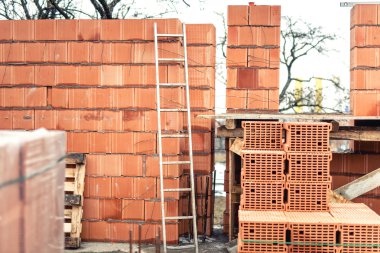 Wall building with professional bricks, construction site of new house clipart