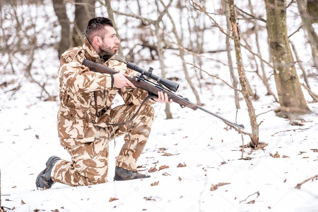 Military man in combat, camouflage uniform preparing for battle with enemy