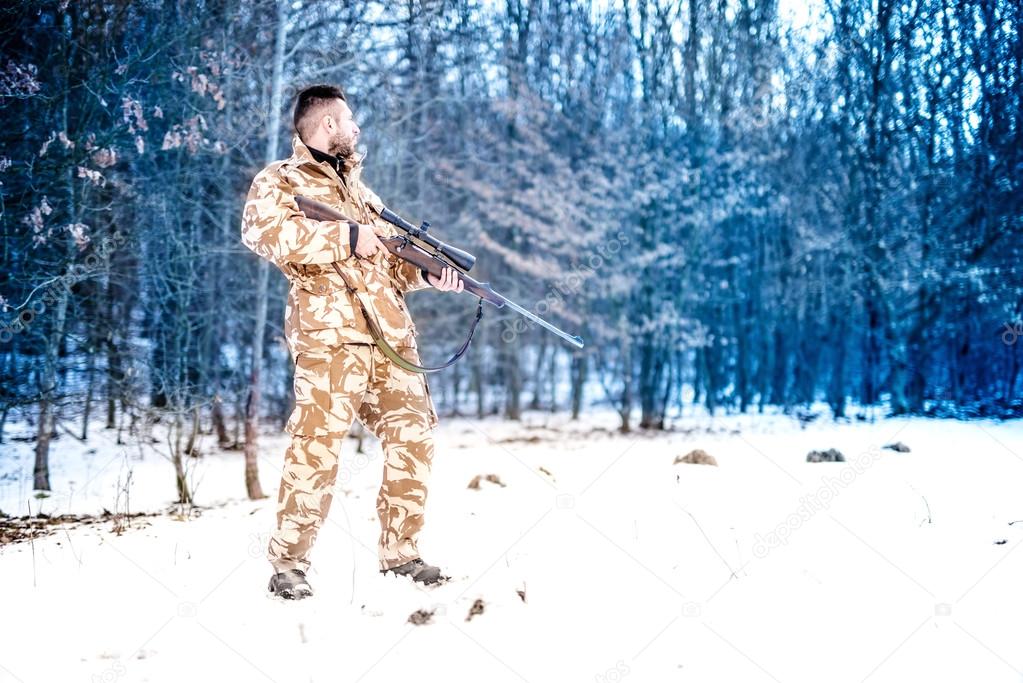 Sniper with weapon ready for combat, special forces army ranger preparing to fire a rifle