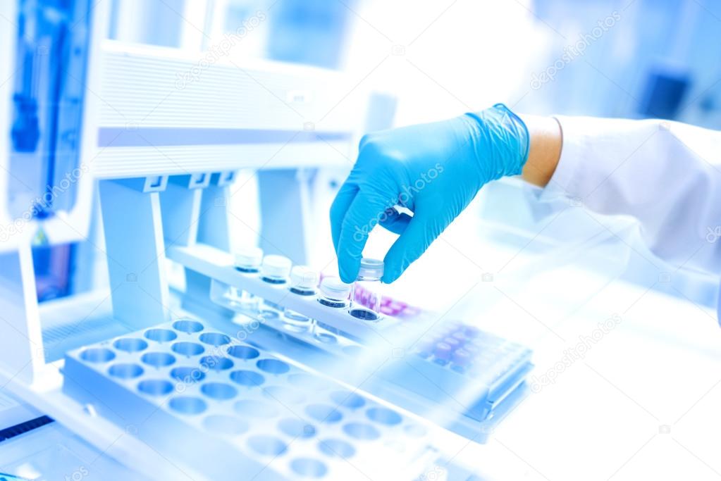 Scientist using protective robber gloves for handling dangerous substances and experiments