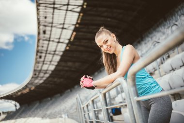 Stadyum merdivenlerde eğitim ve çalışma dışarı güzel genç fitness eğitmeni. Fitness ve sağlıklı yaşam konsepti