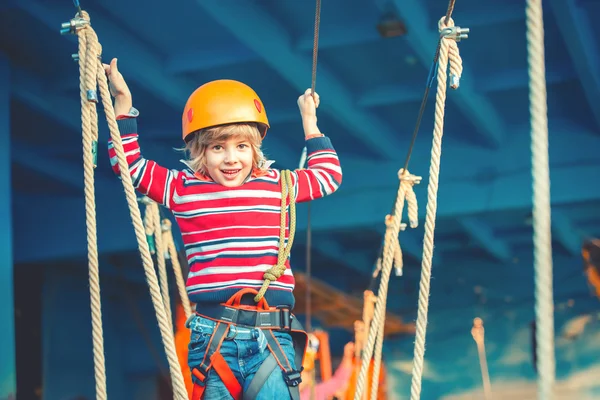 Happy childhood concept - boy playing and exploring activities at park