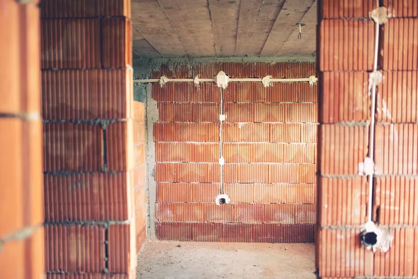 Electric wires instalation and pipes of electricity in new house construction site. — Stock Photo, Image