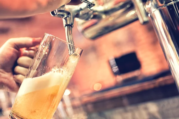 Hand of bartender pouring a large lager beer in tap — Stock Photo, Image