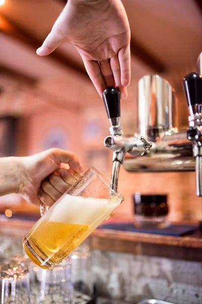 Barman at bistro or pub pouring lager and unfiltered beer in glass — Stock Photo, Image