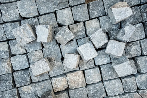 Road pavement, stone blocks and construction tools. Construction worker laying cobblestone pavement stones — Stock Image Road pavement, stone blocks and construction tools. Construction worker laying cobblestone pavement stones Stock Picture