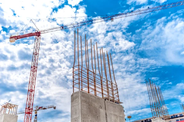 Construction site with industrial crane and close up of reinforced concrete walls, building of skyscraper office building — Stockfoto