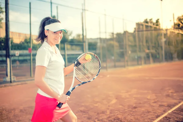 Atrakcyjny brunetka, grać w tenisa i uśmiecha się do kamery. Zdrowego stylu życia nowoczesny, sprawny i wyposażenie dodatkowe — Zdjęcie stockowe