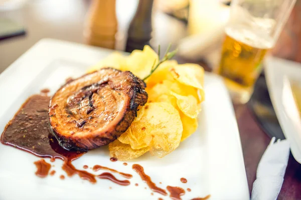 Costoletta di porco alla griglia con patatine fritte come piatto principale al ristorante locale, piatto di fantasia dalla cucina internazionale — Foto Stock