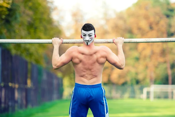 Handsome fit caucasian man, shirtless, doing pull ups in park, outdoors. Fitness training on a summer sunny day, player doing exercises — Stock Photo, Image