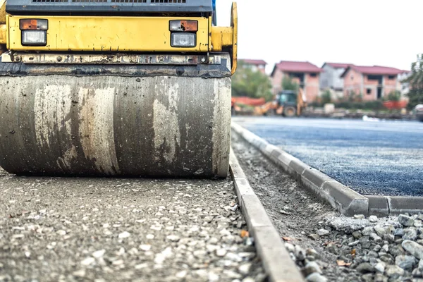Compactador de rodillos de vibración en la construcción de carreteras y reparación de pavimentos de asfalto. compactador que trabaja en el sitio — Foto de Stock