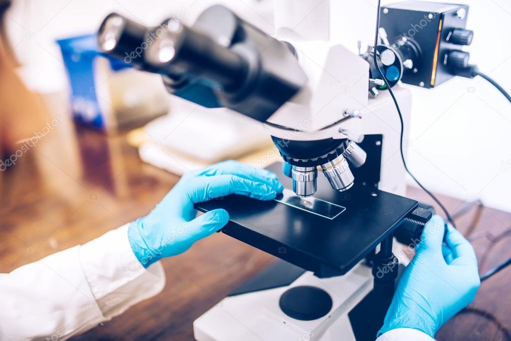 scientist hands using microscope for chemistry test samples and probes. medical and scientific detail equipment or tools