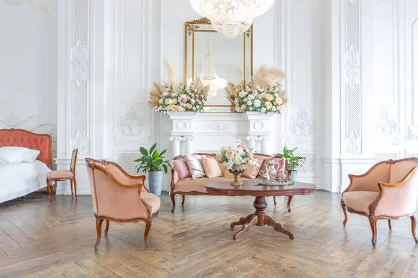 royal baroque style luxury posh interior of large room. extra white, full of day light. high ceiling and walls decorated by stucco