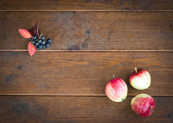 Three apples on the old wooden floor and empty space for text. C